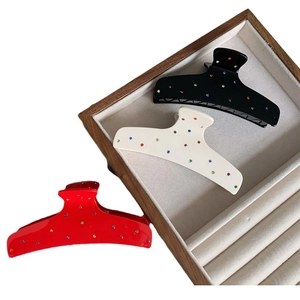 Three large rhinestone acetate shark hair clips in black, cream, and red colors