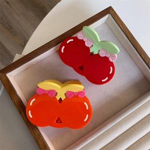 Sweet cherry acetate hair claw clips set with colorful bows on a beige display tray