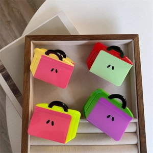 Colorful acetate handbag-shaped hair claws in vibrant contrast colors for women
