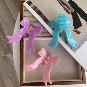 Three-piece acetate bow hair claw set in lavender purple, sky blue, and soft pink colors