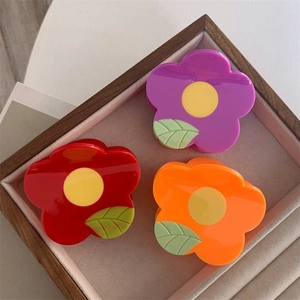 Floral hair claw clips in red, purple and orange colors with green leaf details