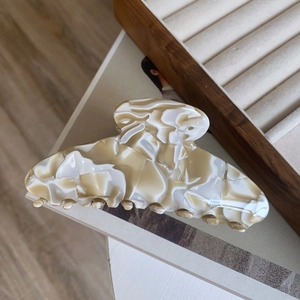 Close-up of elegant marble texture acetate hair claw clip for thick hair styling