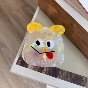 Detailed close-up of a cute cartoon monster hair claw clip with glossy acetic acid finish