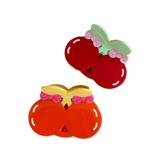 Cute cherry shaped hair claws with pink bows in red and orange acetate finish