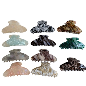 Large acetate hair claw clips set in various marble and tortoiseshell patterns for women