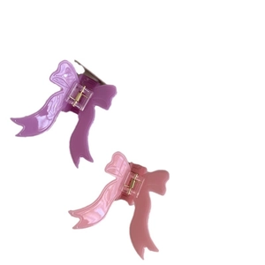 Elegant bow hair claw clip set in pastel purple and pink resin for women