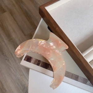 Elegant peach acetate hair claw clip with marble texture for long hair styling