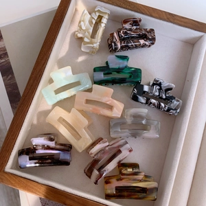 Set of 11 small acetate hair claw clips in marble and tortoise patterns for women