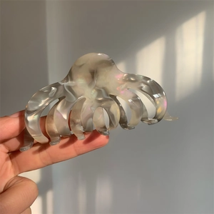 Detailed shot of large smoky gray acetate claw clip with pearlescent mica texture