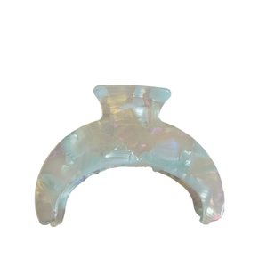 Elegant crescent acetate hair claw clip with blue marble pattern and pearlescent finish