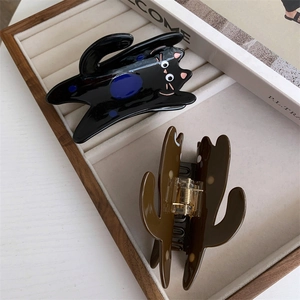 Detail of cute cat claw clips with polka dots on a white jewelry tray display