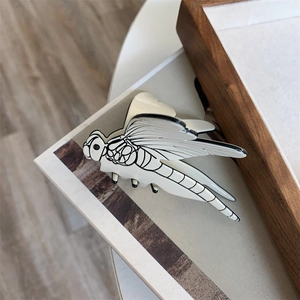 Artistic dragonfly hair claw clip in white acetate with black wing texture details