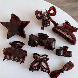 Close-up of red and black plaid pattern hair claws and star-shaped clips set of eight