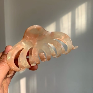 Large pink marble acetate claw clip for thick hair, elegant octopus-style hair accessory