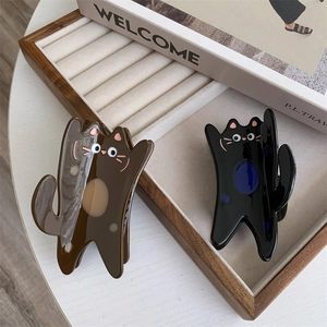 Cute cartoon cat hair claw clips in black and coffee acetate displayed on a wooden tray