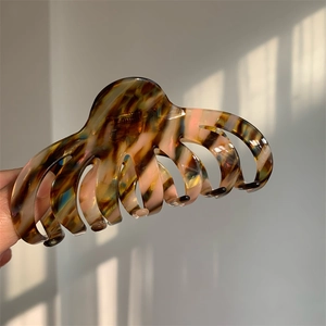 Macro view of octopus claw clip with tortoise marble pattern and smooth acetate finish