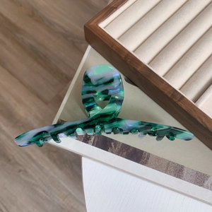 Detail showing marble texture on large acetate hair claw clip for thick hair