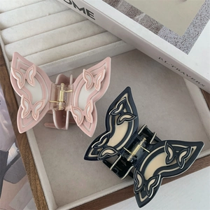 Artistic butterfly hair claw clips set in pastel pink and black white acetate finish