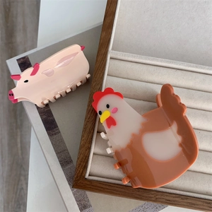 Cute animal hair claws featuring pink pig and yellow hen designs in polished acrylic