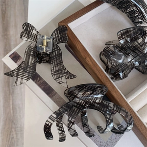 Three-piece black and white checkered hair claw clip set with bow and curved designs