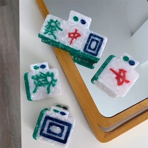 Macro shot of Mahjong themed acetate hair claws featuring intricate marble textures