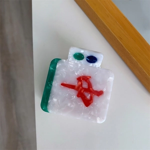 Detailed view of Mahjong-inspired claw clip with green character and marble texture