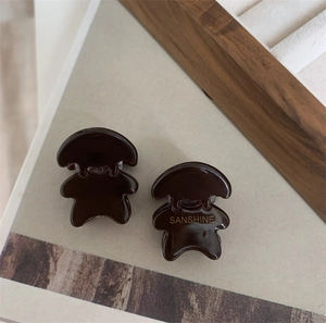 Détail de pinces à cheveux ours en résine marron avec lettrage doré élégant Sanshine