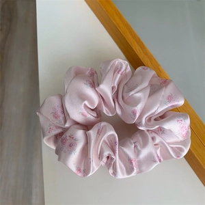 Pink floral satin scrunchie with purple flower patterns for women elegant hair styling