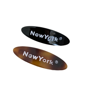 Lot de deux barrettes ovales lettrées New York en coloris noir et écaille de tortue