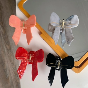 Elegant bow-shaped acetate hair claws in various colors for women's hair styling