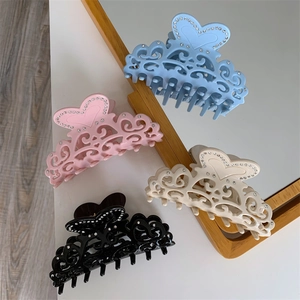 Set of four hollow acetate heart hair claws with rhinestones in blue pink and black