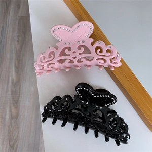 Elegant hollow acetate claw clips with rhinestones in pink and black heart designs