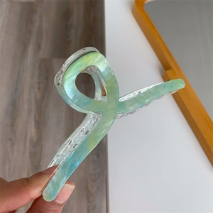 Detail of a large 13cm light blue marble acrylic hair claw clip with strong metal spring
