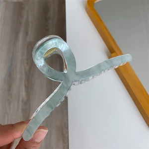 Detail of 13cm double-layered seafoam green acrylic hair claw with strong gold metal spring