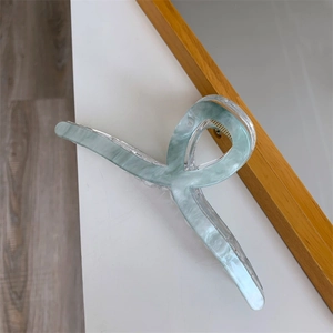 Close-up of a 13cm double-layered acrylic hair claw with mint green marble pattern texture
