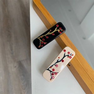 Détails des pinces à cheveux rectangulaires avec fleurs de prunier et strass rouges