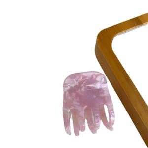 Pink marble pattern acetate hair claw clip with French lettering in minimalist style