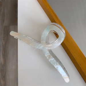 Detail of 13cm oversized acrylic shark hair claw with blue and orange marble texture