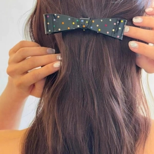 Black bow hair clip with colorful crystal rhinestones worn on hair back view