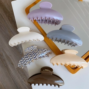 Detail view showing a variety of large acetate hair claw clips in colors and patterns
