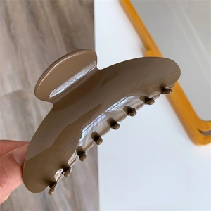 Close-up of a large tortoiseshell acetate claw clip in coffee brown with high gloss finish