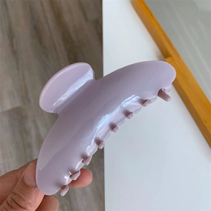 Detail of lavender acetate hair claw clip with glossy finish and durable large teeth