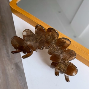 Detailed view of large brown petal hair claw clip with unique cross-hatched texture