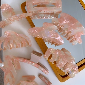 Elegant pink marble acetate hair claw set featuring various shapes for long hair styling
