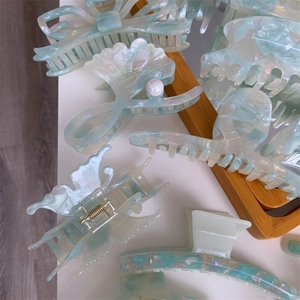 Elegant mint green marble acetate hair claws in butterfly shell and bow designs