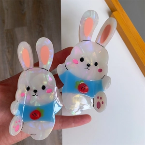 Detailed view of two cute bunny hair claws featuring pearlescent acetate finish and carrot pattern