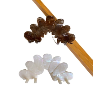Elegant oversized acetate petal hair claws in tortoiseshell and iridescent pearl white