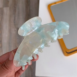Detail of teal acetate ginkgo leaf hair claw clip with pearlescent shell texture
