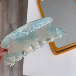 Detailed view of the marble texture on a mint green acetate hair claw clip for women