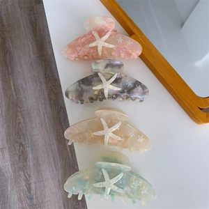 Set of four starfish hair claws in pink, grey, apricot and green marbled acetate